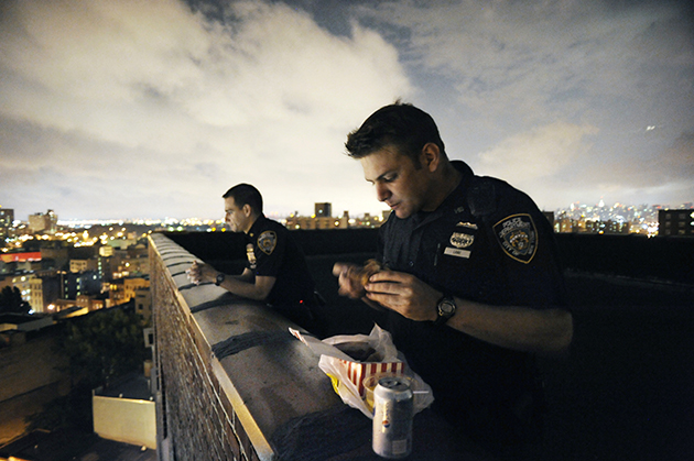 Officers spend their dinner break on a housing project roof.