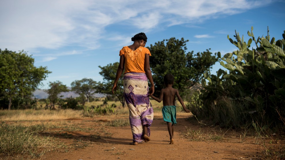 Nana, 24, walks back to her home in Betsingilo, Madagascar with her five-year-old son. She has two children and recently received a birth control implant from a Marie Stopes International mobile clinic.