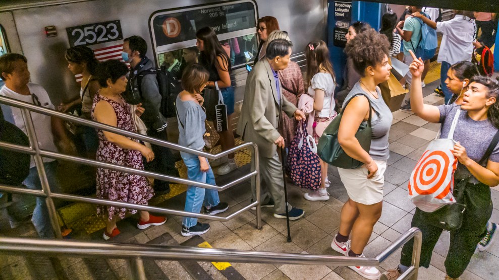 Crowded NYC subway station, with dirty stairs, with people boarding and getting off a subway