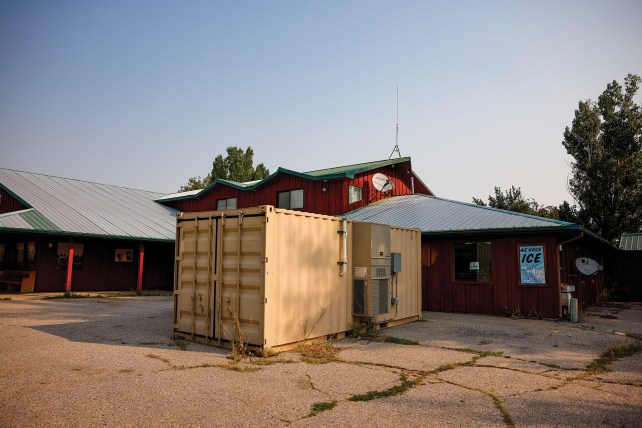 Shipping container turned into a holding cell in a parking lot.