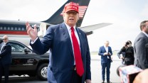 Trump at an airport, in front of his jet.