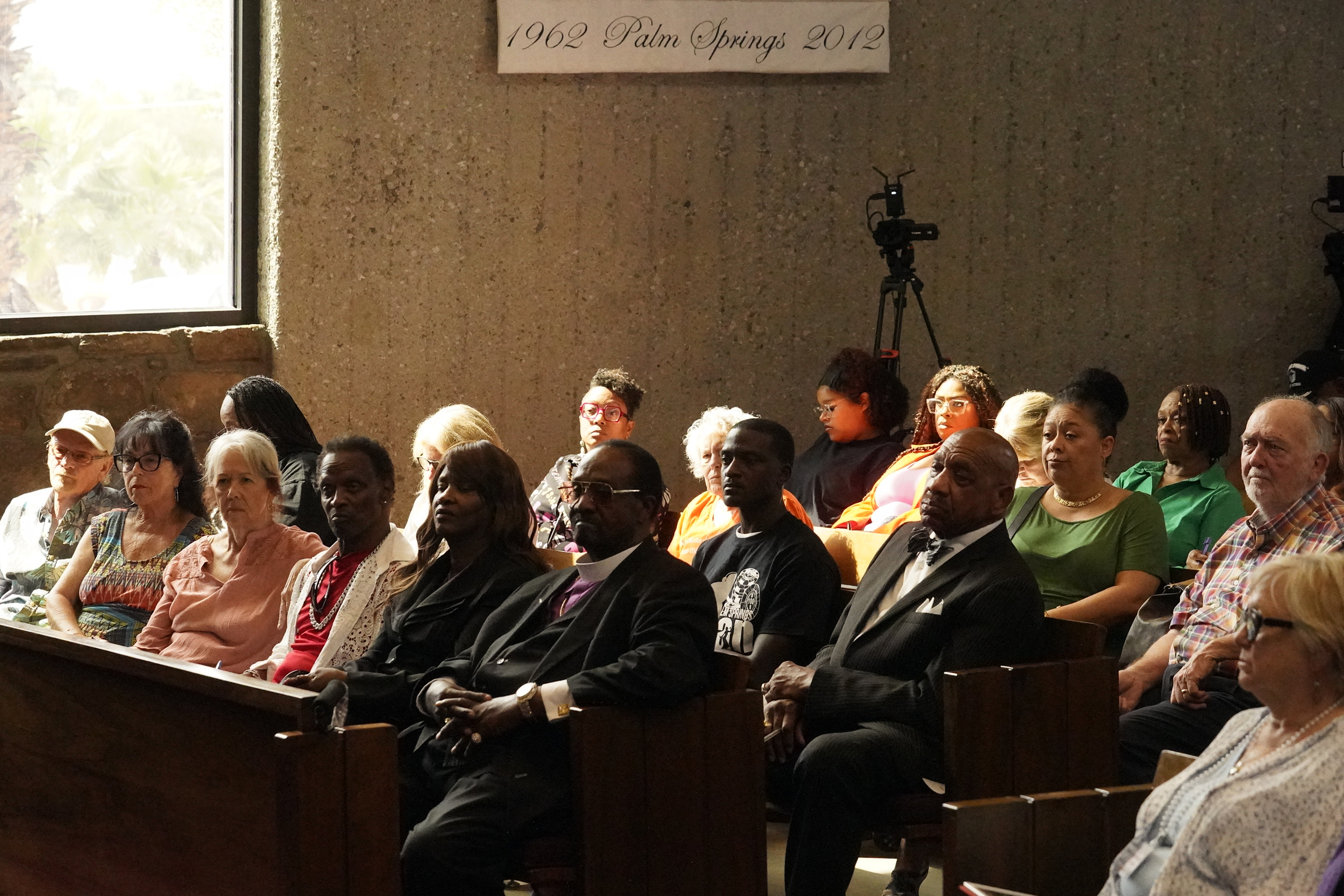 Group of people sitting in a church.