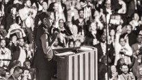 Black and white photo of Michelle Obama speaking at the DNC.