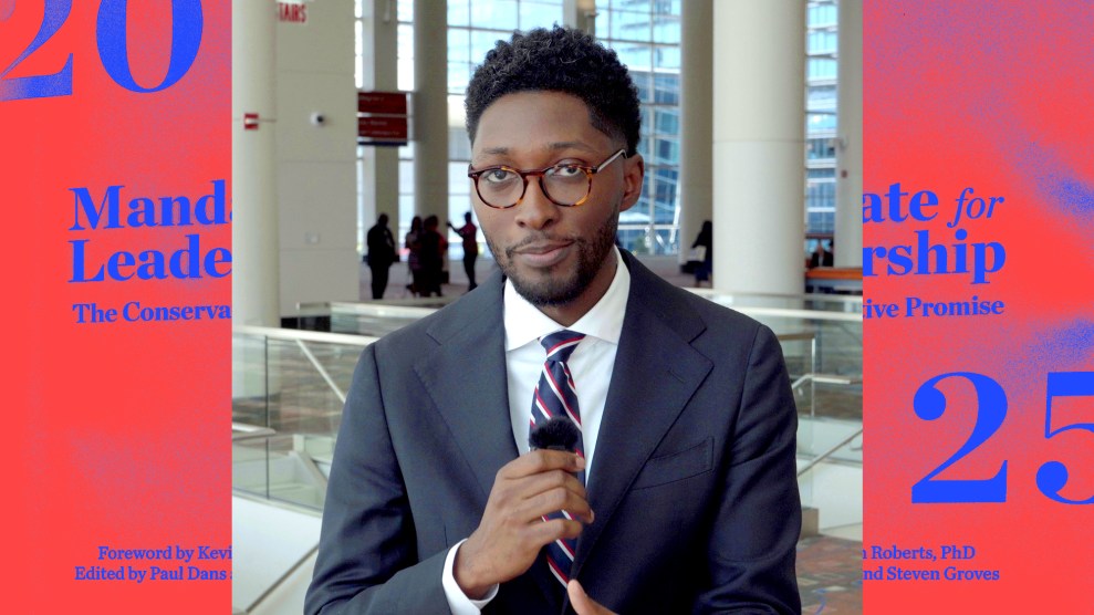 Mother Jones reporter Garrison Hayes holds a microphone and speaks to camera at the DNC.