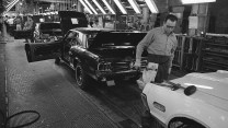 Black and white photo of automotive production line.