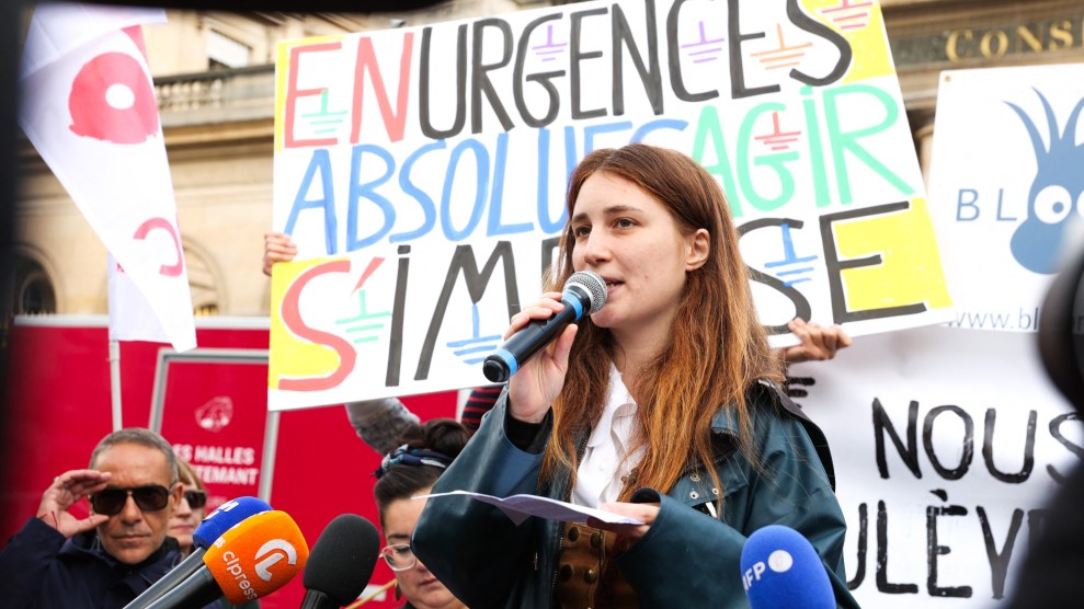 Lena Lazare, a french environmental activist, surrounded by signs at a press conference.