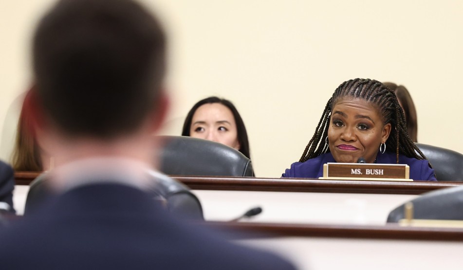 Representative Cori Bush sits in a congressional meeting.