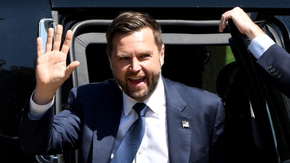 JD Vance exits a vehicle and waves while campaigning.