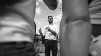 A black and white photo of JD Vance speaking in front of a group of people