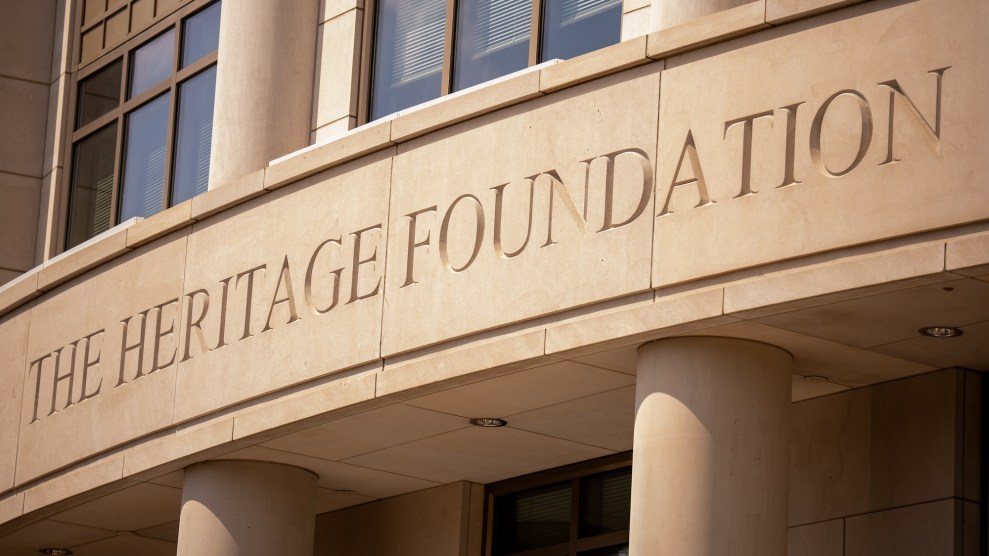 A large engraved stone portico reading "The Heritage Foundation," at the front of a large office building.