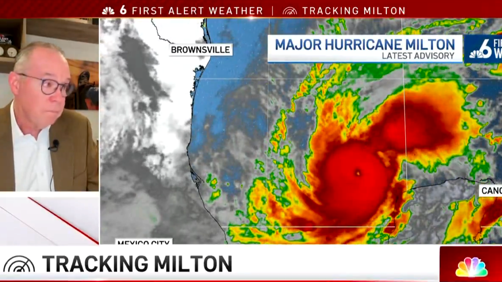 Miami meteorologist John Morales, in glasses and jacket over white shirt, looks with great concern at a radar rendering of Category 5 Hurricane Milton in the Gulf of Mexico as it barrels toward Central Florida.