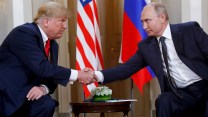 President Donald Trump, left, and Russian President Vladimir Putin shake hands at the beginning of a meeting.