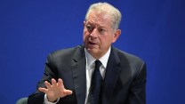 Al Gore speaks in front of a blue backdrop