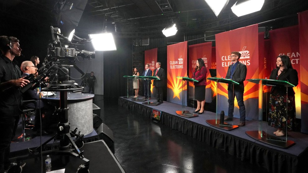 multiple people stand on stage for a debate