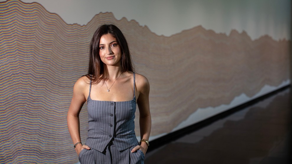 Portrait of woman standing with her hands in her pockets.