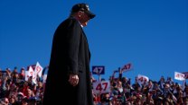 Donald Trump in front of a crowd at a rally