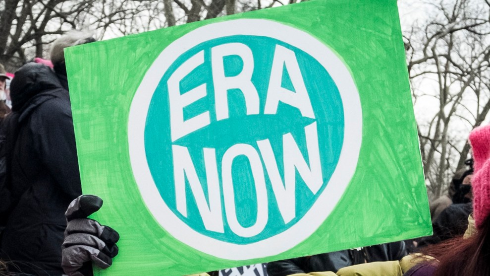 A protester holds a sign that says ERA Now