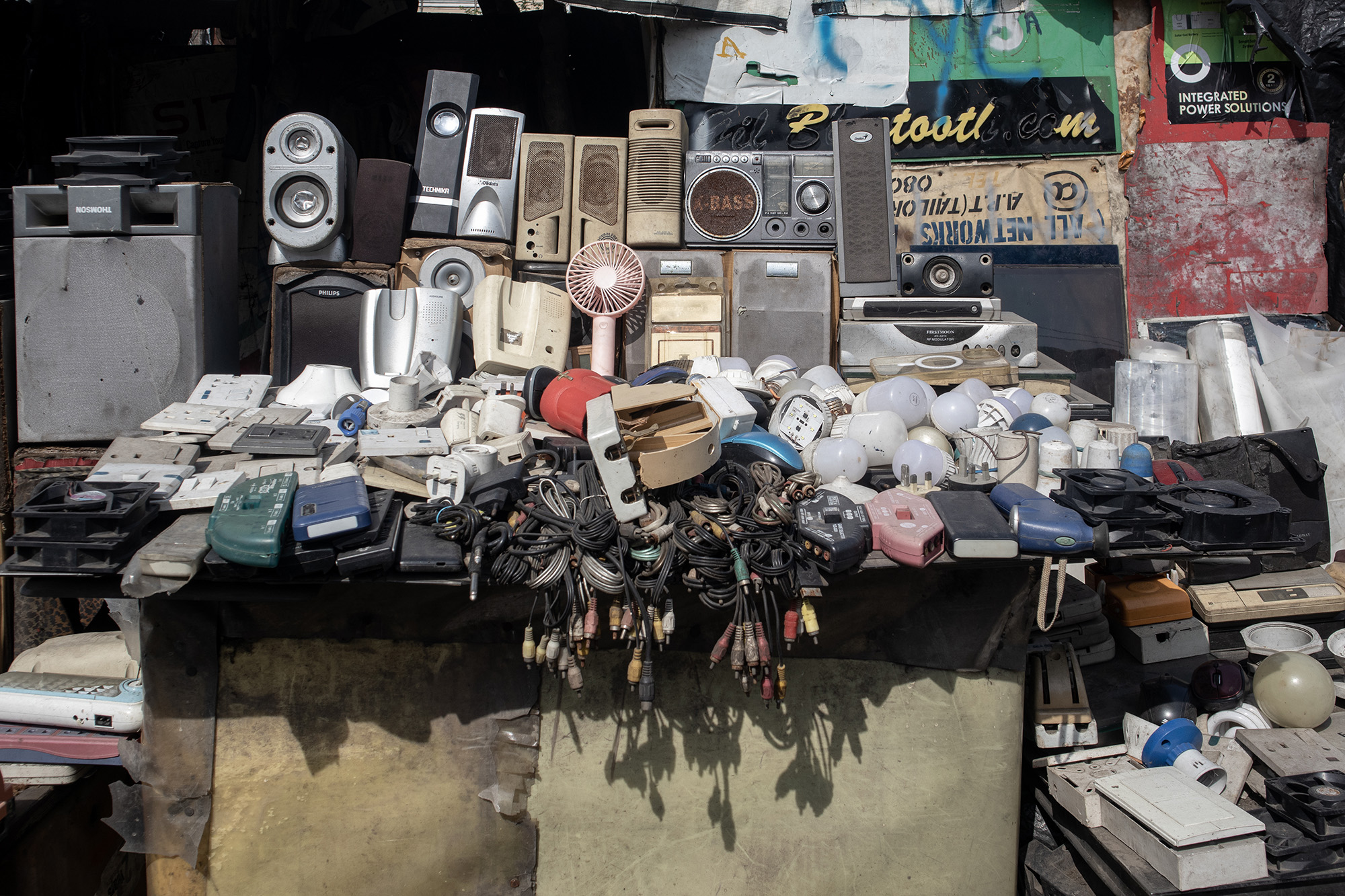 Pile of used electronics on a table.