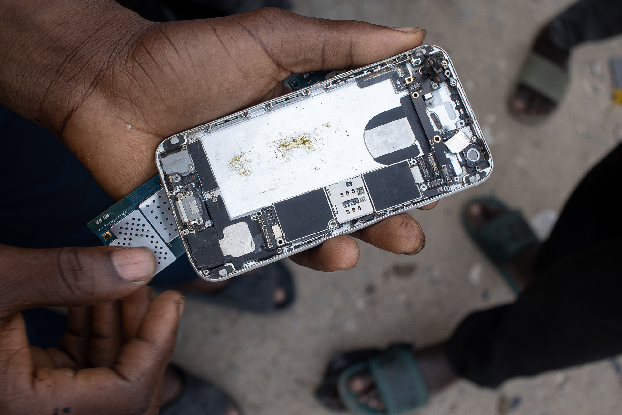 Disassembled cellphone in a man's hand.