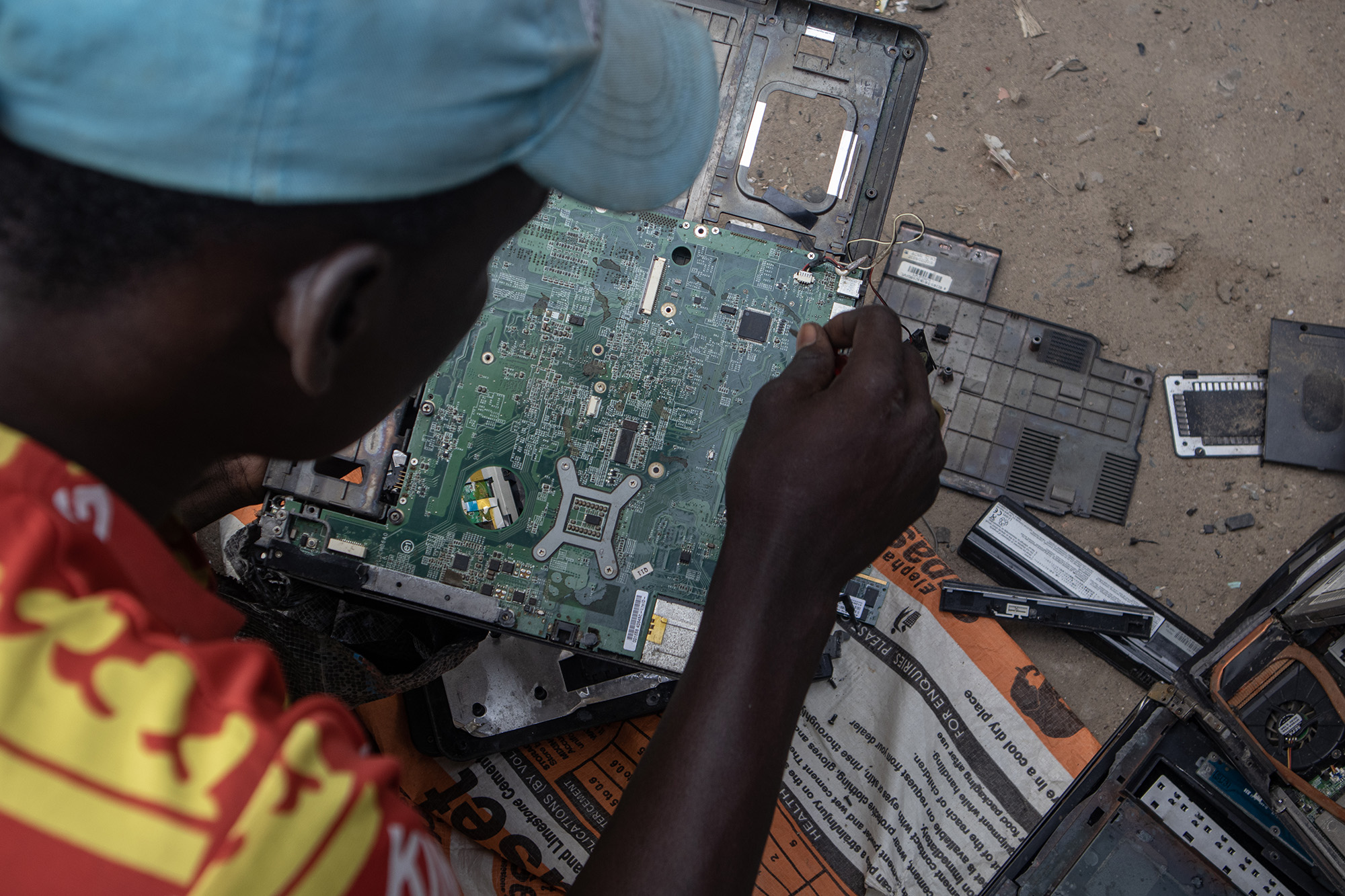 Man with a computer circuit board on his lap.