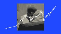 A line chart trending up is overlayed on top of an image of a worried man reading a piece of paper