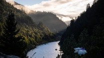 A river cuts through green mountains