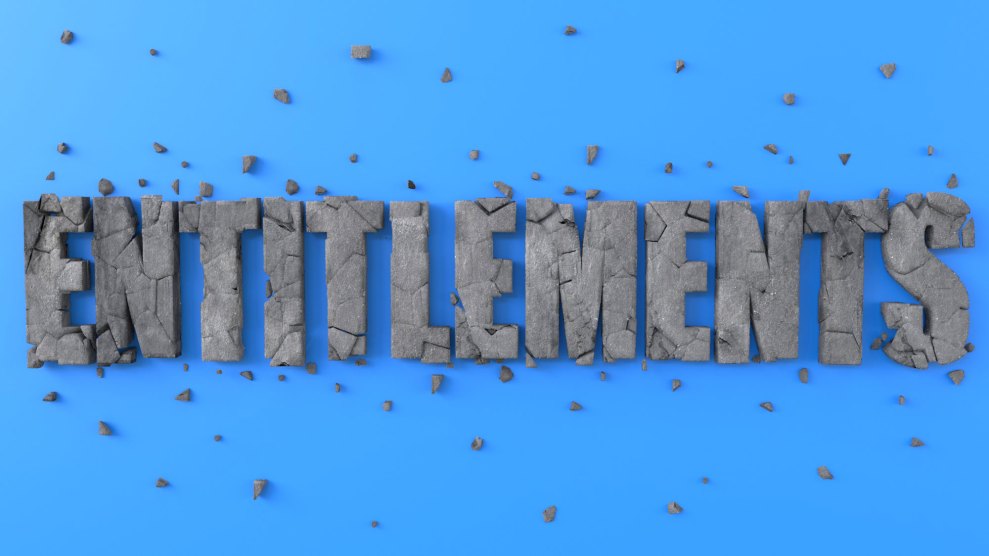 The word "Entitlements' spelled out in all caps in what appears to be stone against a blue background. The stone is greatly fractured with bits of fallen stone scattered around it.