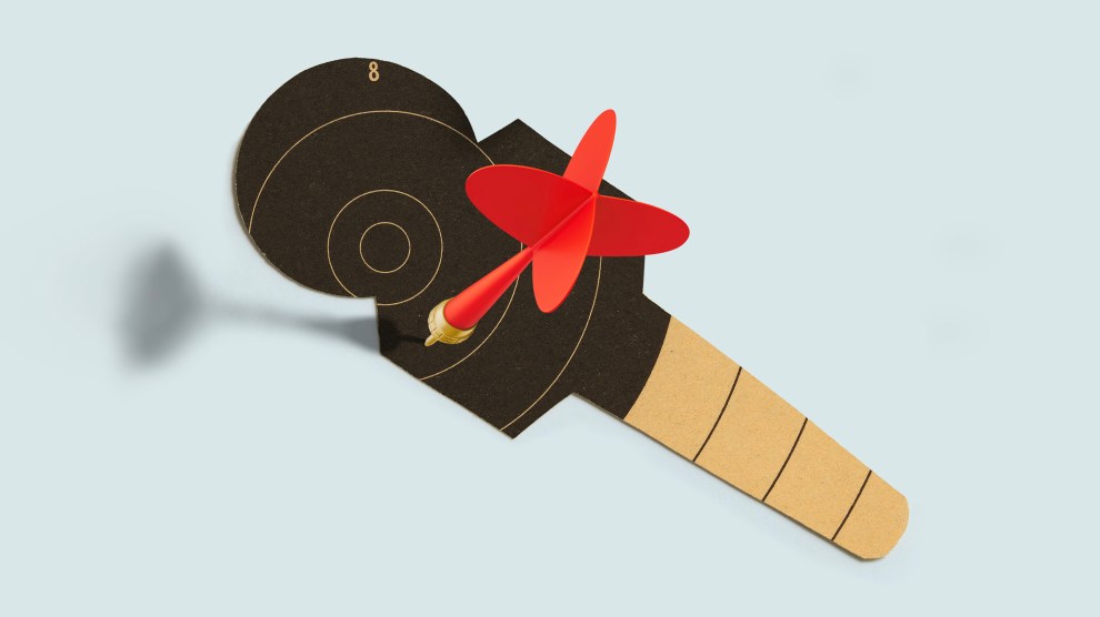 A target cut into the shape of a microphone, with a red dart sticking out of it.