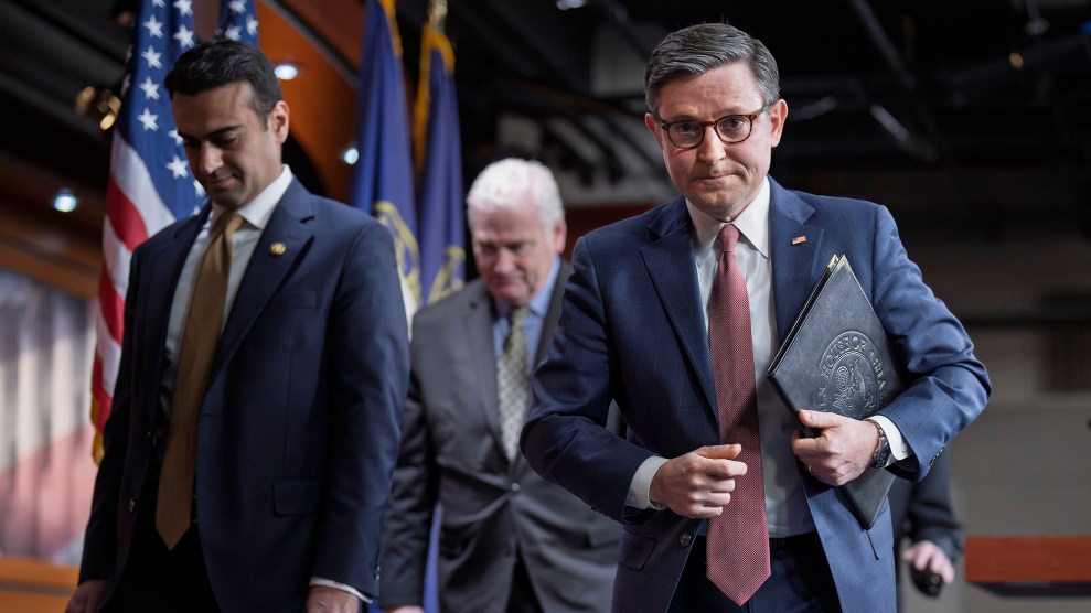 Speaker of the House Mike Johnson walks towards the camera with two other Congressmen.