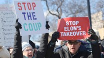 Protesters hold signs that read, "Stop the coup," and, "Stop Elon's takeover."