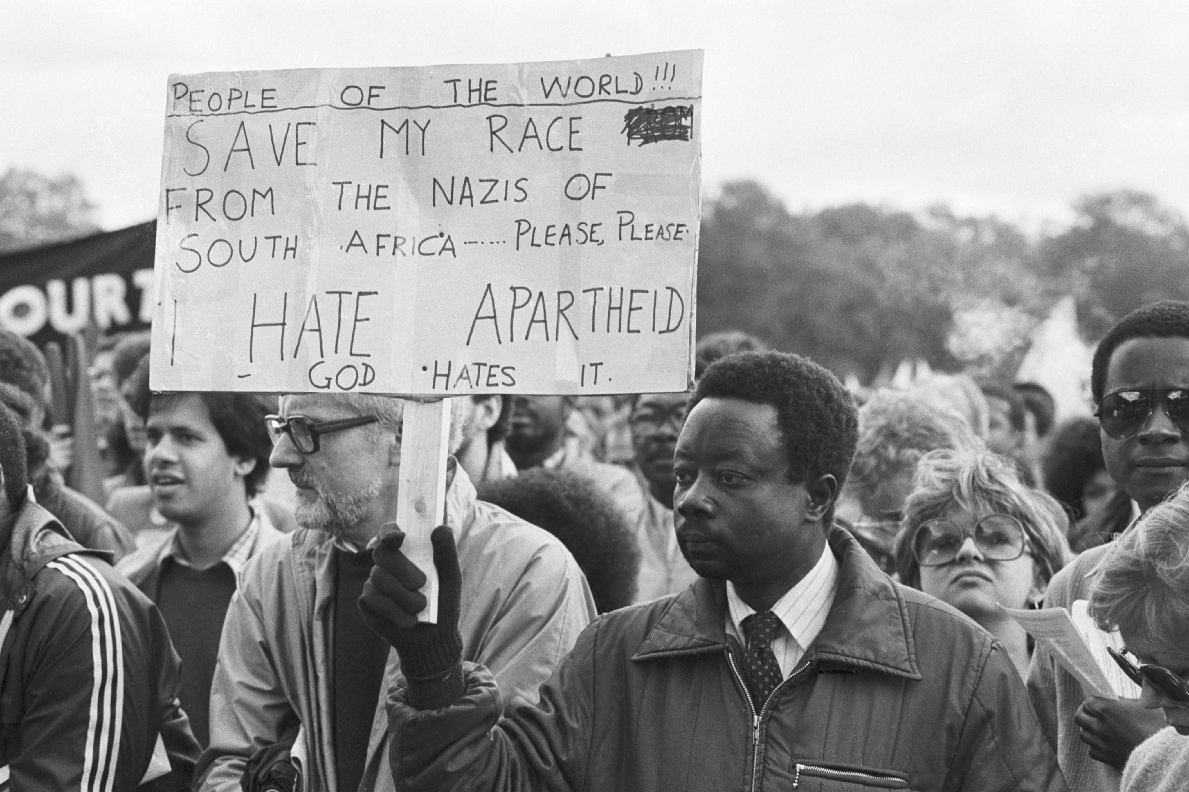 Anti-Apartheid protester holding a sign.