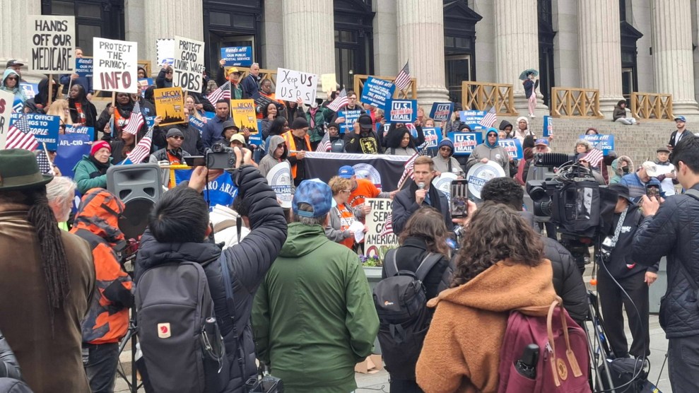 New York City Council member Erik Bottcher is speaking to the crowd outside the James A. Farley Building in Manhattan during a American Postal Workers Union protest.
