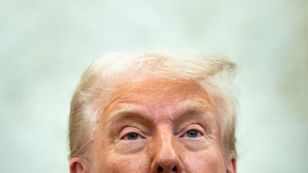 President Donald Trump looks on during a meeting.