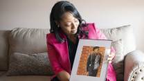 Candace Leslie holds a photo of her late son, Cameron Brown, who was shot and killed in Indianapolis in 2021.