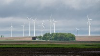 A photo of a handful of wind turbines in a field in Iowa