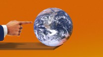 An earth and hand pointing to it on an orange background.