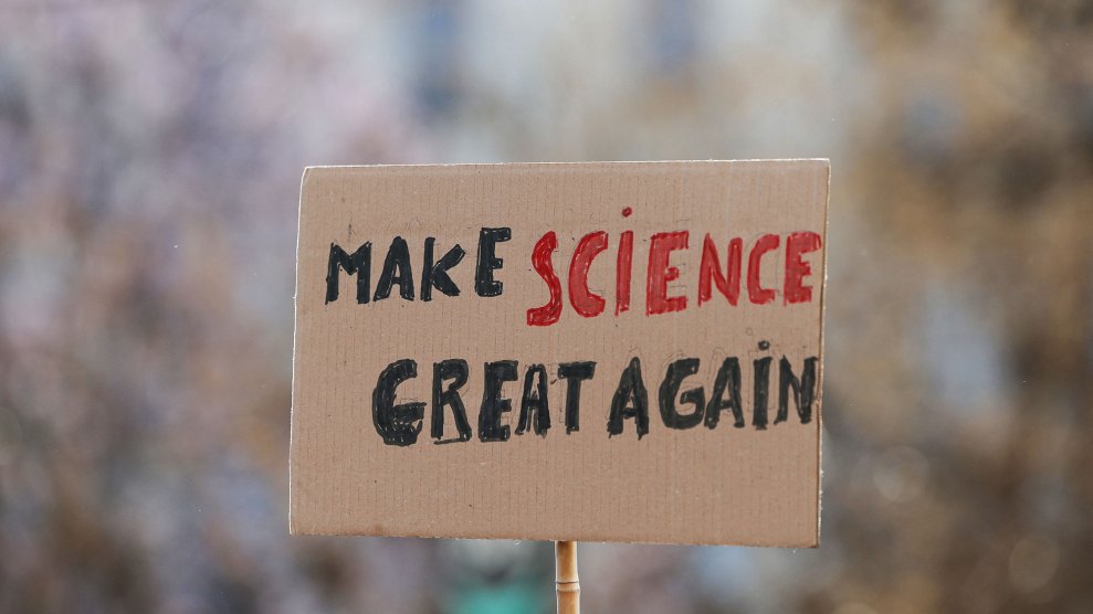 A cardboard sign, with clunky handwritten letters, reading "Make Science Great Again." Science is in red. The rest is in black.