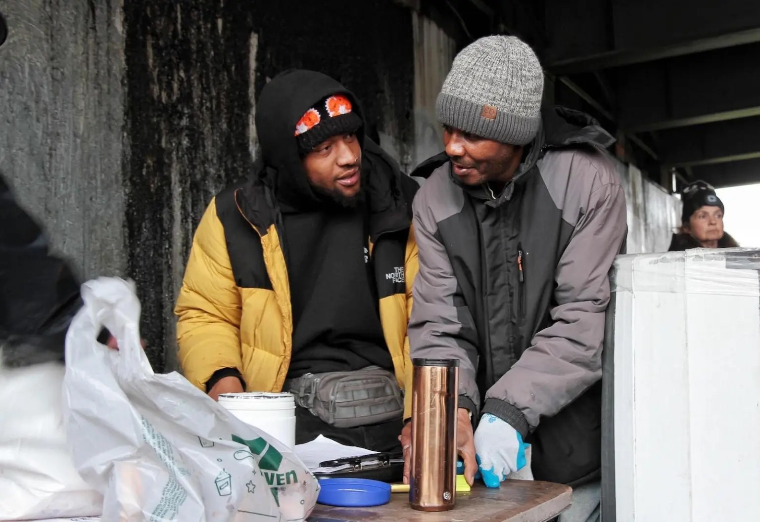 Two people look at each other outside.