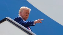 Donald Trump points as he boards Air Force One while leaving Qatar on Thursday May 15.