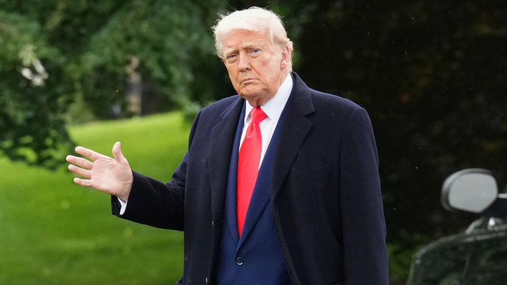 Donald Trump in a blue suit and red tie leaving the White House on May 22.