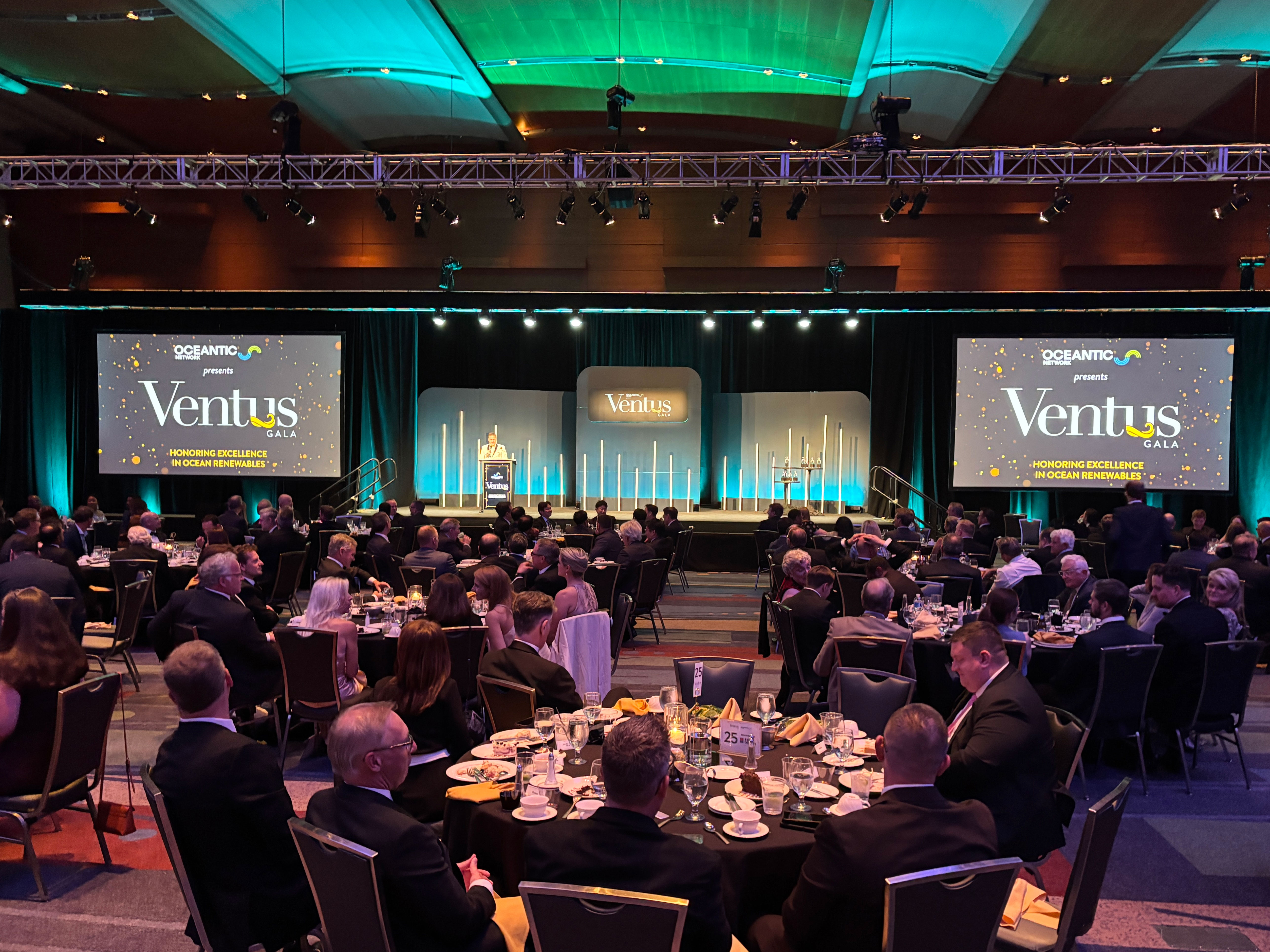 A darkened ballroom with round tables and screens reading "Ventus"—at an awards gala for the offshore wind industry