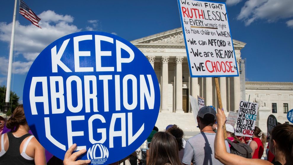 Protestors outside the U.S. capitol hold signs demanding to keep abortion legal