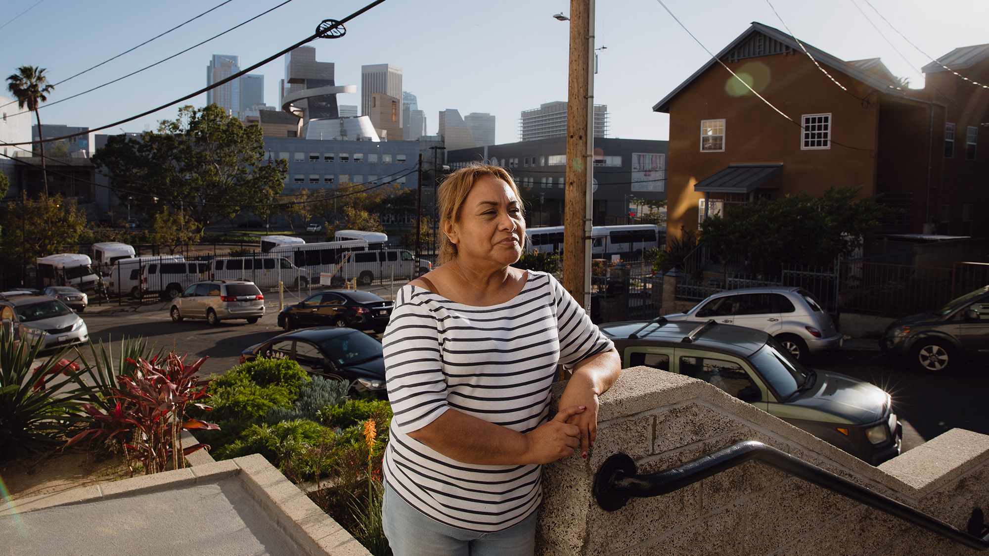 Monica Ruiz stands on the steps of Hillside Villa, a low-income housing complex in Los Angeles