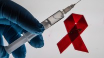 photo illustration shows a medical syringe and an AIDS ribbon in the background