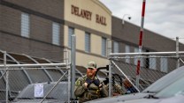 Officer stands at the gates of Delaney Hall Detention Center in New Jersey.