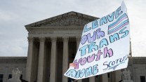 Sign held up outside US Supreme Court building reading 'Leave our trans youth alone SCOTUS'