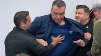 Sen. Alex Padilla tries to move forward as he's manhandled by two federal officers.