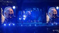 Bruce Springsteen pictured on Jumbotron screens at a concert.