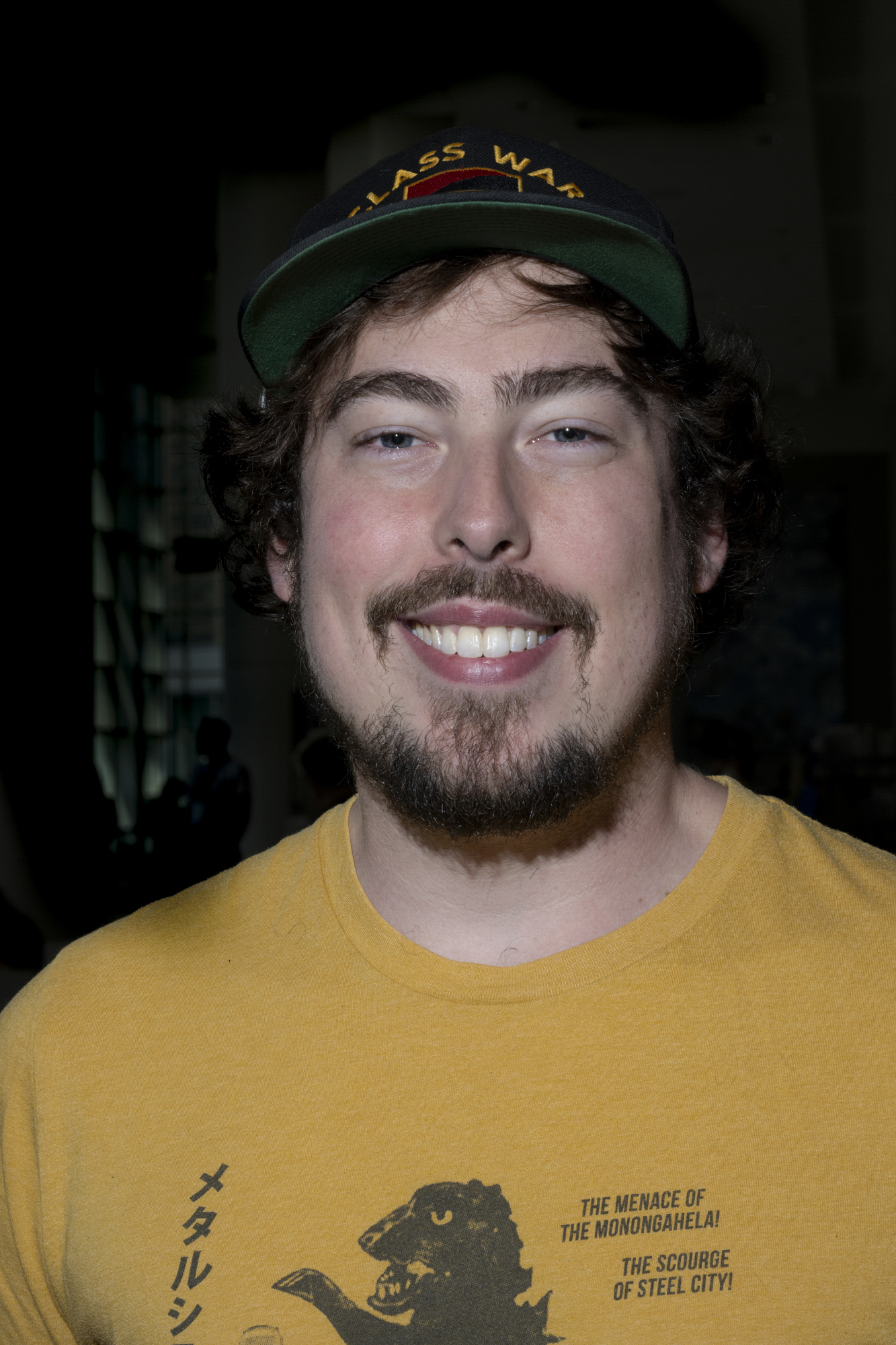 Portrait of man in yellow shirt.