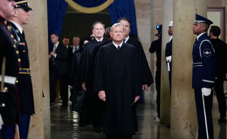 John Roberts walks through the U.S. Capitol. Justices Samuel Alito, Brett Kavanaugh, and Clarence Thomas walk behind him.